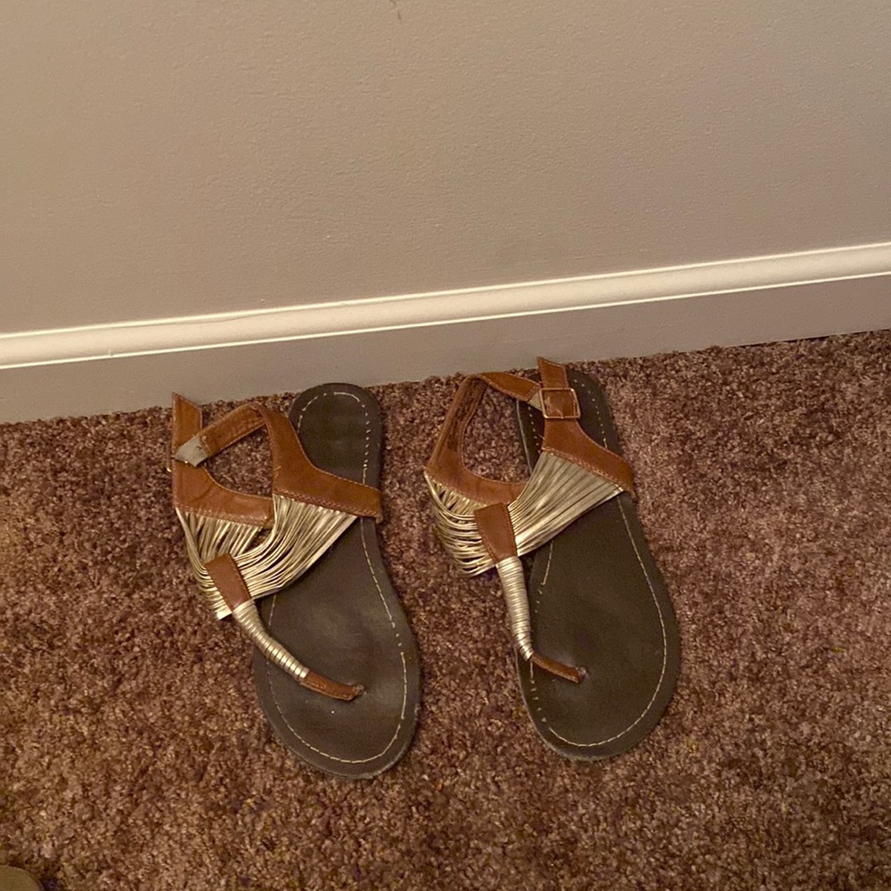 Worn brown and gold hot cakes sandals size 7.